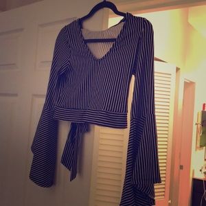 Size medium half shirt with bell bottom arms .